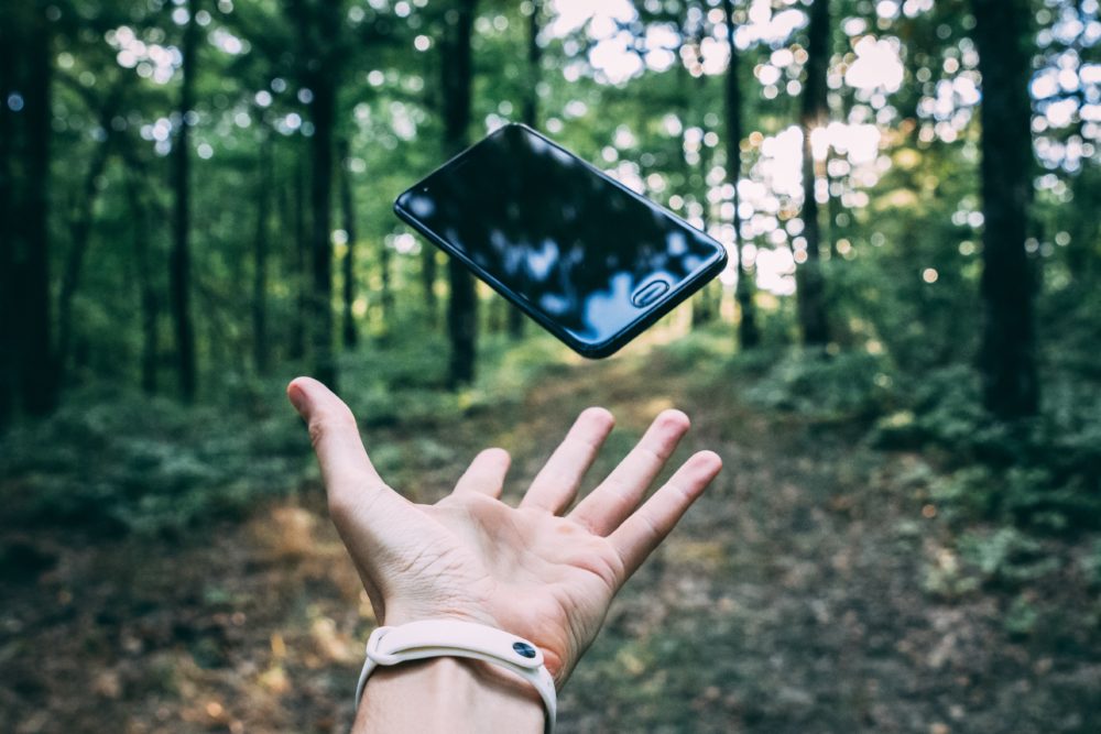 person throwing black smartphone